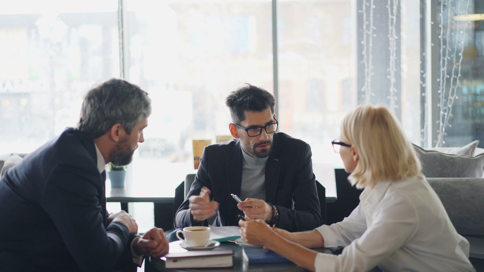 A mediator facilitating a calm discussion between two people at a table